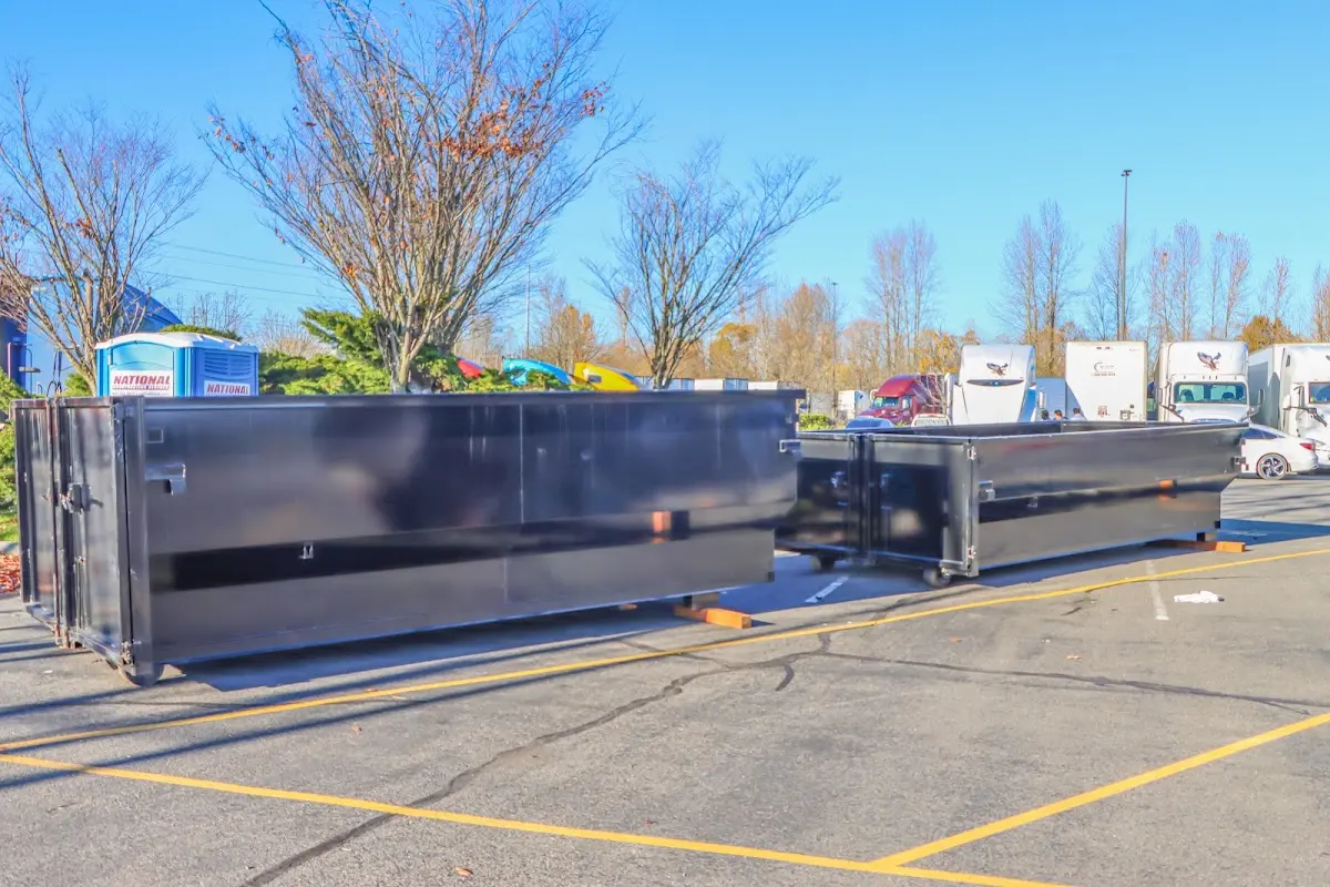 Professional dumpster rental service with roll-off container on residential driveway in Bountiful